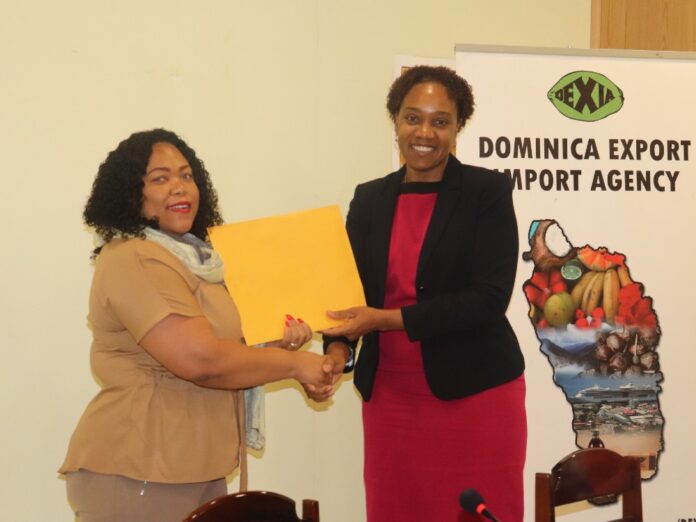 Dr. Kyra Paul, PS in the Ministry of Agriculture accepts the coca financial model from CREAD CEO Francine Baron