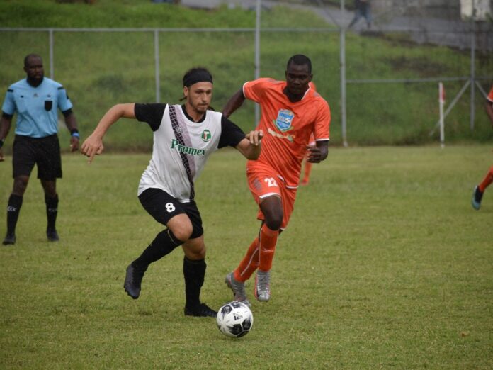 Harlem FC player in white being challenged for the ball