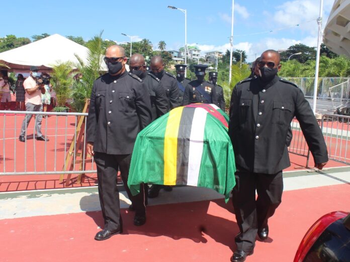 Police officer carrying casket of Edward Registe