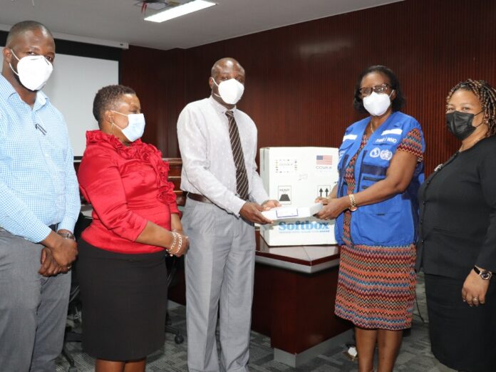 Handing-over-Pfizer-Vaccine-from-left-to-right-Dr-Keevian-Burnette-Coordinator-Vaccination-Programme
