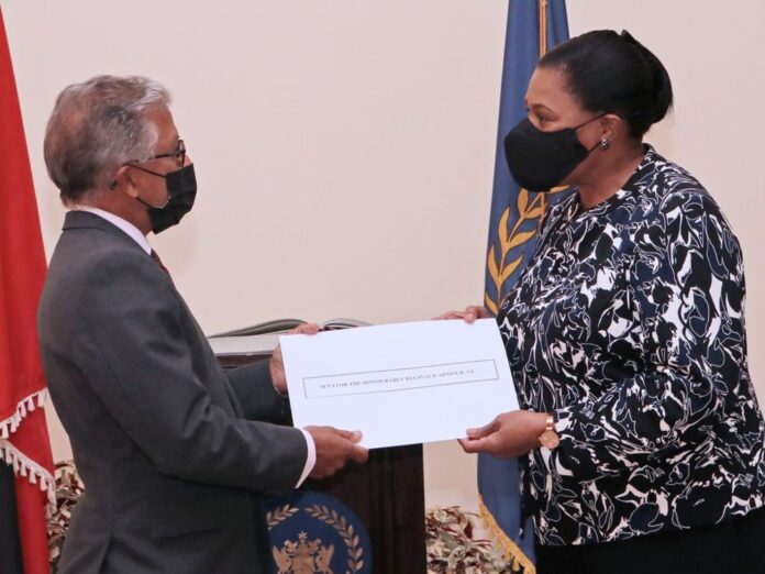 Reginald Armour SC receives his instrument of appointment from President Paula Mae Weeks