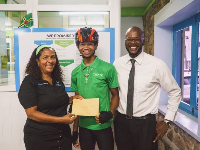 SAGICOR DONATES TO KOHATH BARON: From right: Cheryl Rolle, General Manager and Principal Representative for Sagicor; Kohath Baron, national cyclist and Ronald Charles, President, Dominica Cycling Association