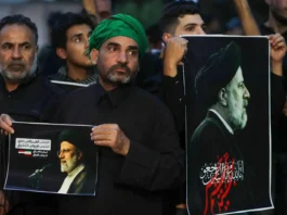 Iraqis carry portraits of Iran's late President Ebrahim Raisi outside the Iranian embassy in Baghdad during a condolences service on May 20, 2024 for the president and his entourage, who were killed in a helicopter crash in Iran the previous day. (Photo: AFP)