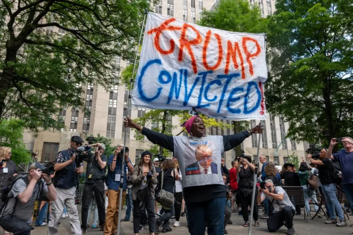 NEW YORK, United States - People celebrate after former President Donald Trump was found guilty on all counts at Manhattan Criminal Court on May 30, 2024 in New York City. Trump faced 34 felony counts of falsifying business records in the first of his criminal cases to go to trial. (Photo: AFP)