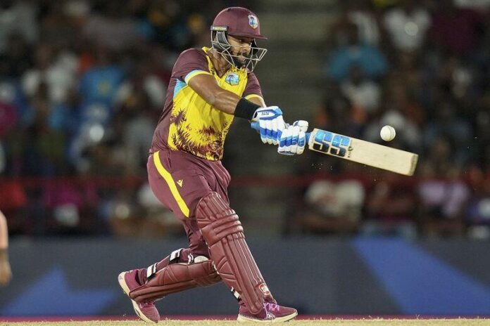 West Indies' Nicholas Pooran hits out against Afghanistan during an ICC Men's T20 World Cup Group C match at the Daren Sammy National Cricket Stadium in Gros Islet, St Lucia, yesterday. -Photo: AP Ramon Espinosa