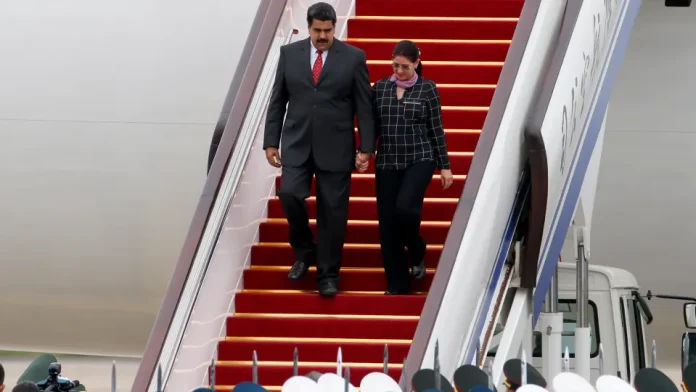 FILE – Venezuela’s President Nicolas Maduro, left, and first lady Cilia Flores arrive at Beijing Capital International Airport in Beijing, China, Sept. 1, 2015. (AP Photo/Ng Han Guan, File)