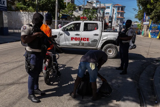 Police officers conduct searches in a suburb of Port-au-Prince, Haiti earlier this month. Guerinault Louis / Anadolu via Getty Images