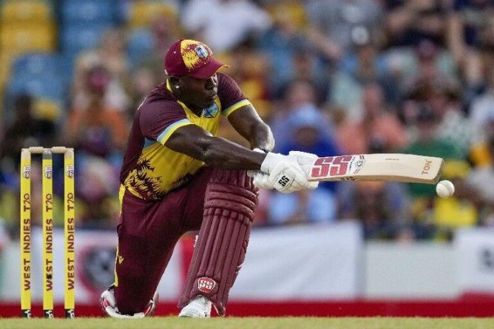 SWEPT AWAY: West Indies captain Rovman Powell gathers runs through the on side during his top-score knock of 43 against England, in yesterday’s second T20I match at Kensington Oval, in Bridgetown, Barbados. —Photo: AP