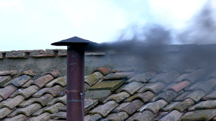 Black smoke rises