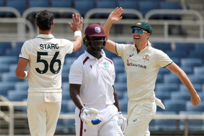 Australia’s captain Pat Cummins (R) congratulates Mitchell Starc after he dismissed West Indies’ Kevlon Anderson (C) on day three of the third Test at Sabina Park in Kingston, Jamaica, on July 14. - AP Photo