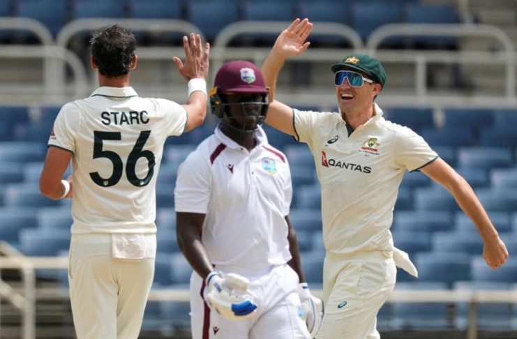 Australia’s captain Pat Cummins (R) congratulates Mitchell Starc after he dismissed West Indies’ Kevlon Anderson (C) on day three of the third Test at Sabina Park in Kingston, Jamaica, on July 14. - AP Photo