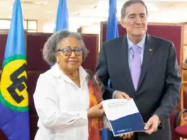 Caricom Secretary General Carla Barnett and PAHO Director, Jarbas Barbosa show off the agreement signed on Tuesday. (Photo:CMC)