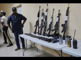 Weapons that police say were seized from alleged gang members sit on display for the media during a press conference at police headquarters in Port-au-Prince, Haiti, Tuesday, August 26, 2025.(AP Photo/Odelyn Joseph)