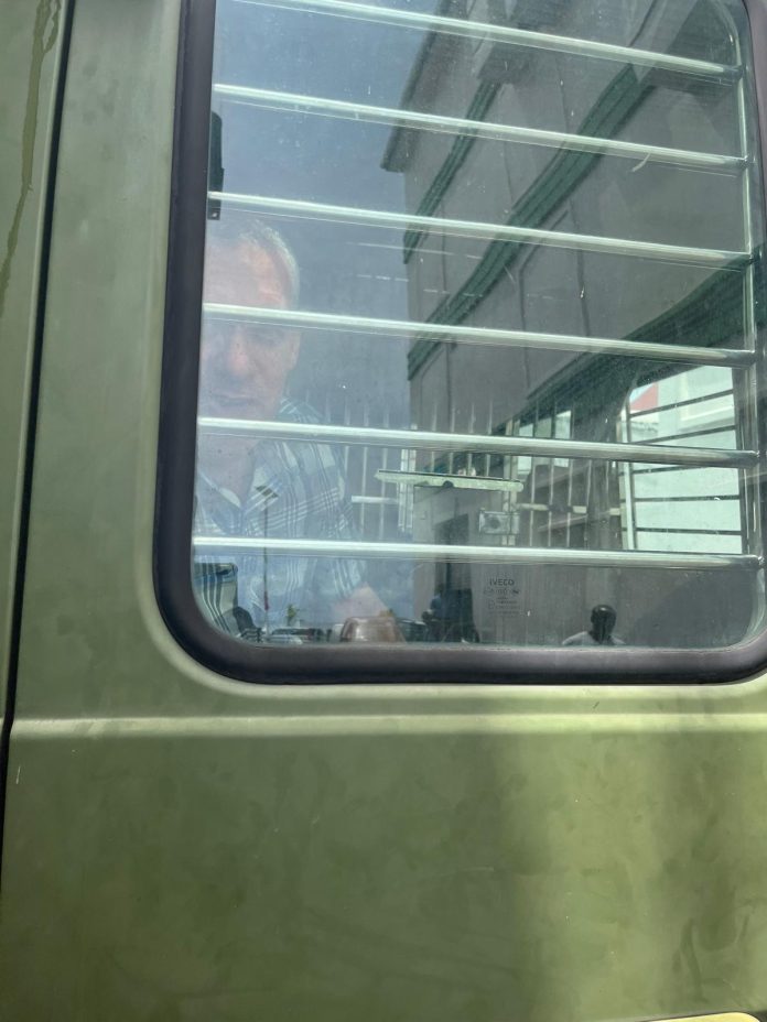 Jonathan Lehrer in prisoners van and Roberts Snider Jr ( hiding) taken back to prison
