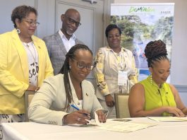 Barbados Tourism Marketing Inc.’s Chief Executive Officer, Andrea Franklin (seated left) and DDA Director, Marva Williams, signing the MOU between Barbados and Dominica while (standing from left to right) BTMI’s COO Cheryl Carter; BTMI’s Director (Caribbean) Graham Clarke; and Marketing Executive at DDA, Lise Cuffy, look on. (BTMI)