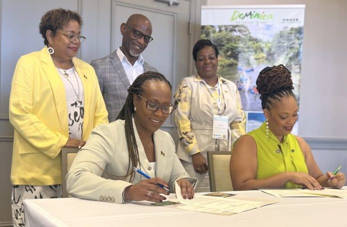 Barbados Tourism Marketing Inc.’s Chief Executive Officer, Andrea Franklin (seated left) and DDA Director, Marva Williams, signing the MOU between Barbados and Dominica while (standing from left to right) BTMI’s COO Cheryl Carter; BTMI’s Director (Caribbean) Graham Clarke; and Marketing Executive at DDA, Lise Cuffy, look on. (BTMI)
