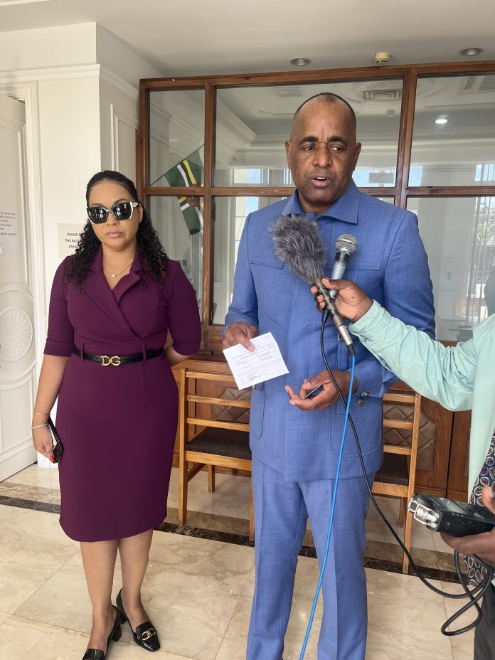 PM Skerrit and wife Melissia speaks to the press and shows his receipt after his re-registration-photos Nature Isle News (NIN)
