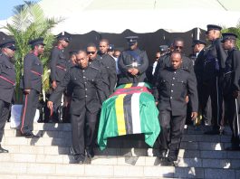 The flag draped casket of the late Julius C Timothy being carried by police officers