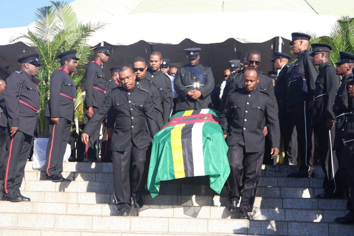 The flag draped casket of the late Julius C Timothy being carried by police officers