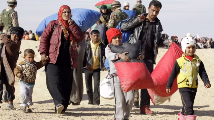 A Syrian refugee family crosses into Jordan, at the Hadalat border crossing in January © AFP
