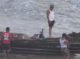 ST. VINCENT-SECURITY-St. Vincent authorities confirm missile strike on vessel in local waters Vincentians watch what’s left of a vessel destroyed by a US missile last Friday (CMC Photo)