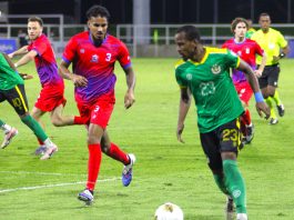 Dominica team (Green Shirt) with ball