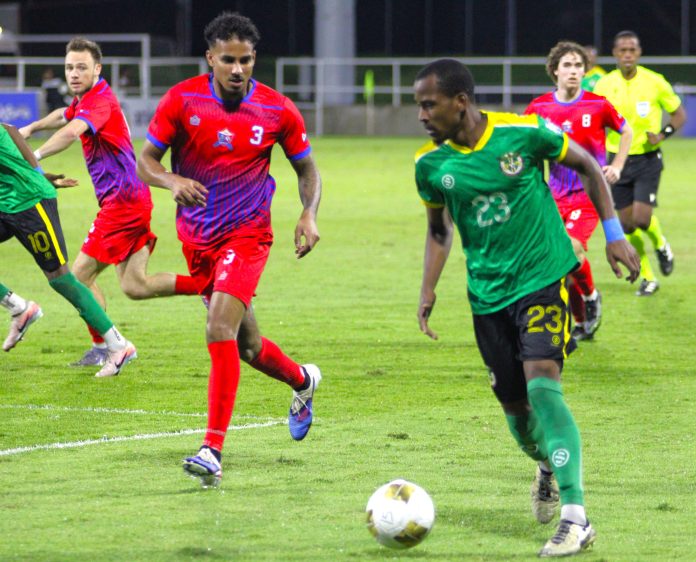 Dominica team (Green Shirt) with ball