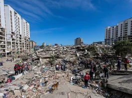 Residents on Tuesday search through the rubble of a building that collapsed in the June 24 earthquakes in La Guaira, Venezuela. Ariana Cubillos/AP