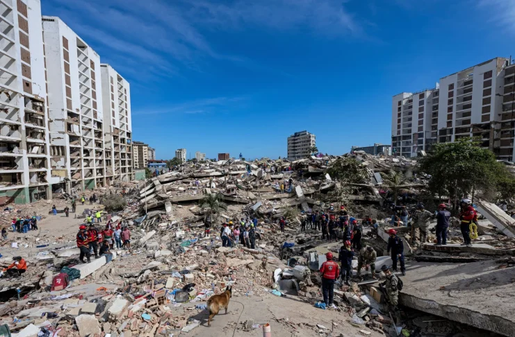Residents on Tuesday search through the rubble of a building that collapsed in the June 24 earthquakes in La Guaira, Venezuela. Ariana Cubillos/AP